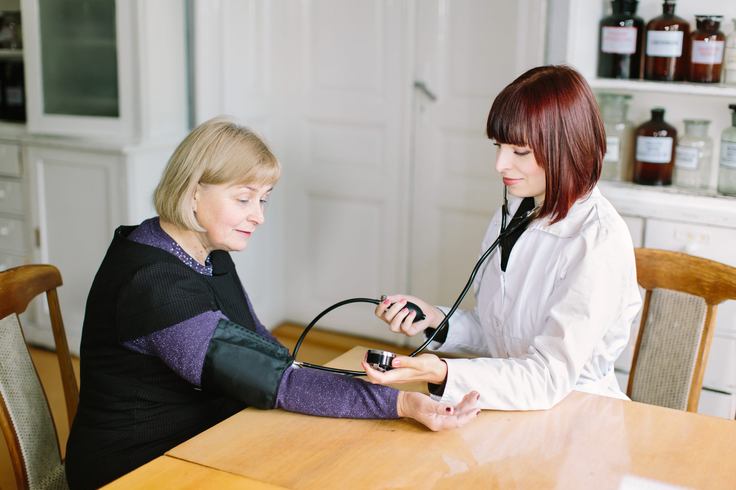 Woman,Pharmacist,Or,Doctor,Measuring,Blood,Pressure,Of,Middle-aged,Blond